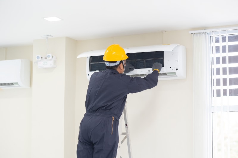 Technician Repairing AC